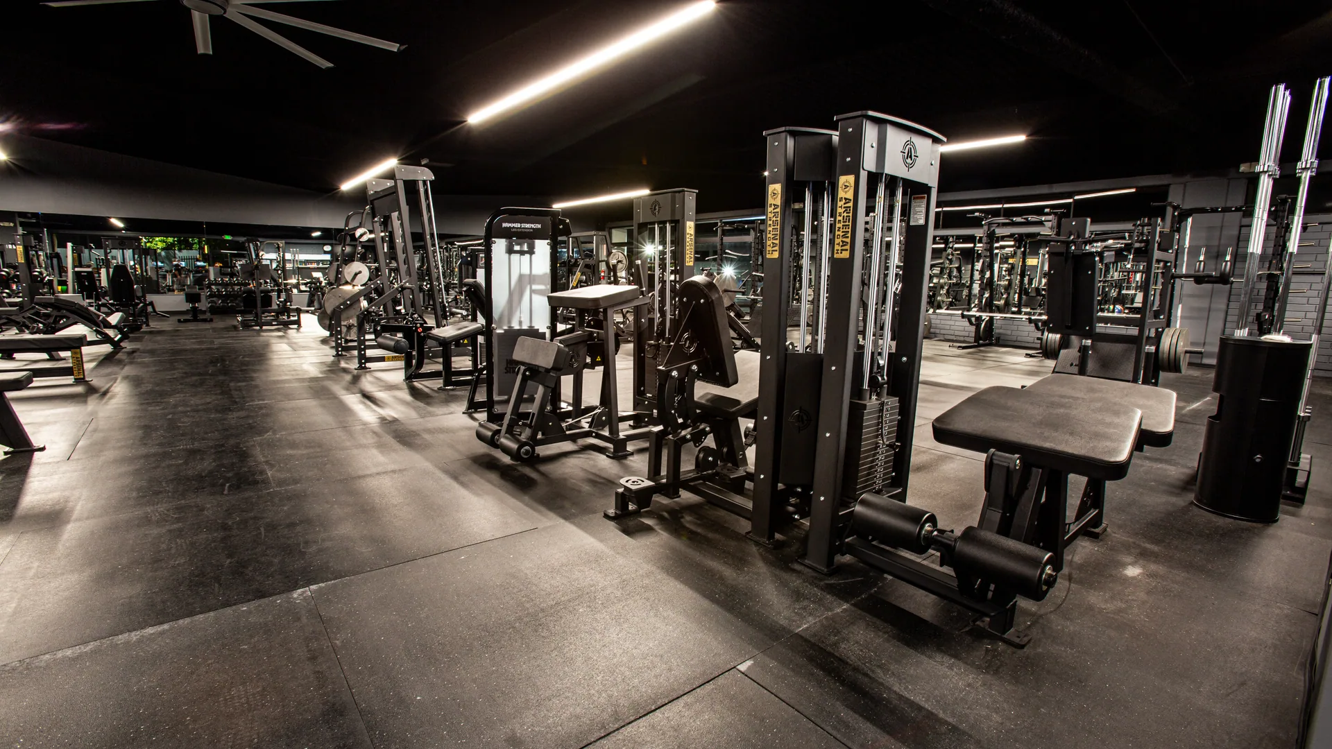 Machines and benches across the floor beneath the ceiling fans