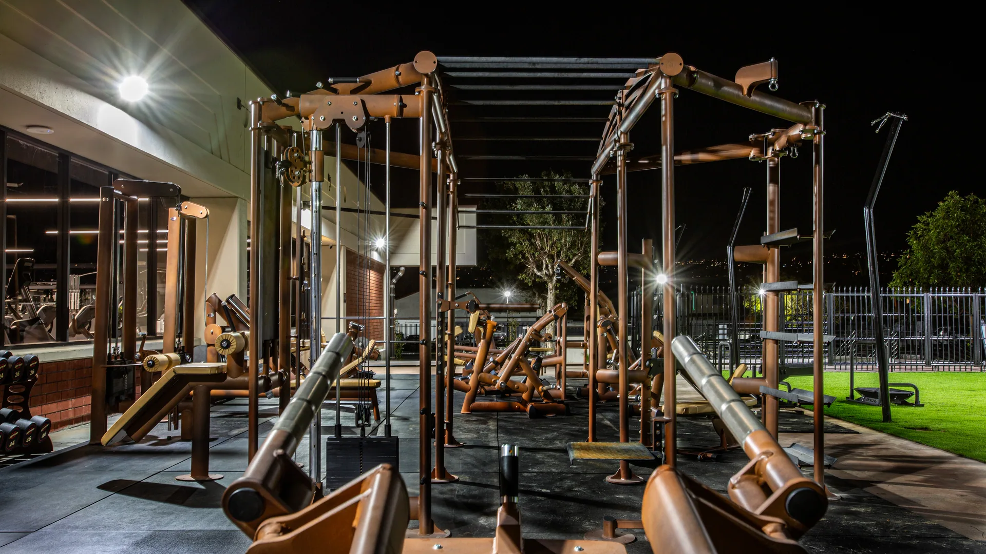 Outdoor strength zone at night under the shade sails